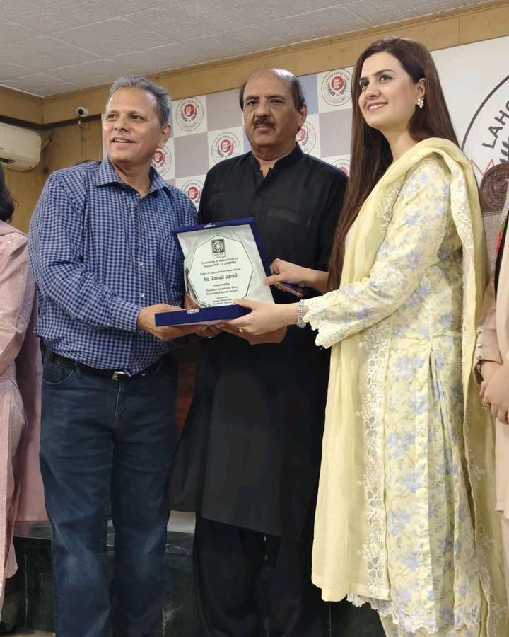 Zaineb Danish receiving recognition on stage